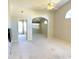 Open living room featuring neutral paint, vaulted ceiling, and archway to a dining area at 6193 Magpie Dr, Lakeland, FL 33809