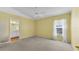 Bright main bedroom features a ceiling fan, neutral carpet, and an en suite bathroom at 6193 Magpie Dr, Lakeland, FL 33809