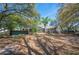 Large backyard with screen porch, mature trees and kayaks to be used on the water at 6615 Broken Arrow S Trl, Lakeland, FL 33813