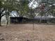 Backyard view of the exterior of the home and screened in porch at 6615 Broken Arrow S Trl, Lakeland, FL 33813