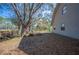 Leaf-covered backyard with a fire pit area, and a partial view of the home's siding at 6615 Broken Arrow S Trl, Lakeland, FL 33813