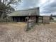 Exterior view of the barn with multiple entrances and gating at 6615 Broken Arrow S Trl, Lakeland, FL 33813