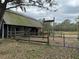 Horse barn with metal roof and wooden fencing at 6615 Broken Arrow S Trl, Lakeland, FL 33813