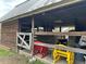 Barn interior featuring a wooden fence, farm equipment, and wagon wheel decorations at 6615 Broken Arrow S Trl, Lakeland, FL 33813