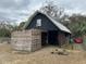 Barn with sliding wooden door and a metal roof at 6615 Broken Arrow S Trl, Lakeland, FL 33813