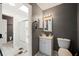 This bathroom has gray walls, a white vanity, and a shower-tub combination at 6615 Broken Arrow S Trl, Lakeland, FL 33813