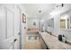 Bright bathroom with a built-in tub and extended vanity area at 6615 Broken Arrow S Trl, Lakeland, FL 33813