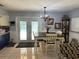 Dining area with chandelier and white wainscotting, and a view of the pool through French doors at 6615 Broken Arrow S Trl, Lakeland, FL 33813