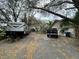 Long driveway with mature trees, RV, and truck on the property at 6615 Broken Arrow S Trl, Lakeland, FL 33813