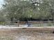 View of the exterior of the home with a wooden fence surrounding the perimeter at 6615 Broken Arrow S Trl, Lakeland, FL 33813