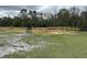 View of newly installed wooden fencing and trees surrounding the property at 6615 Broken Arrow S Trl, Lakeland, FL 33813