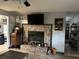 Living area showcasing a stone fireplace, tile floor, and natural light with vintage record player at 6615 Broken Arrow S Trl, Lakeland, FL 33813