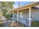 Inviting front porch featuring a seating area and well-maintained landscaping, perfect for relaxing outdoors at 6615 Broken Arrow S Trl, Lakeland, FL 33813