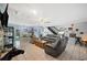 Bright living room with tile flooring, a staircase and views of the dining area, creating a modern appeal at 6615 Broken Arrow S Trl, Lakeland, FL 33813