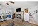 Living room with a stone fireplace and a view into the adjacent kitchen and hallway at 6615 Broken Arrow S Trl, Lakeland, FL 33813