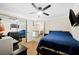 Comfortable bedroom featuring a ceiling fan and a tv on the wall at 6615 Broken Arrow S Trl, Lakeland, FL 33813