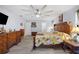 Bright main bedroom featuring wood floors, large windows, and ample closet space at 6615 Broken Arrow S Trl, Lakeland, FL 33813