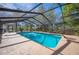 Beautiful pool with screened enclosure offering privacy and a view of the surrounding greenery at 6615 Broken Arrow S Trl, Lakeland, FL 33813