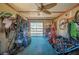 Tack room featuring a ceiling fan, a window for natural light, and a variety of horse riding equipment at 6615 Broken Arrow S Trl, Lakeland, FL 33813