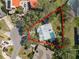 Aerial view of property featuring a swimming pool and spacious yard outlined in red at 7410 Locksley Ln, Lakeland, FL 33809