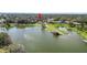 Aerial view of a lakeside home with mature trees and manicured lawns at 7410 Locksley Ln, Lakeland, FL 33809