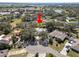 Aerial view of property with a large back yard, mature trees, and a circular driveway at 7410 Locksley Ln, Lakeland, FL 33809