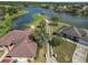 Aerial view of waterfront homes featuring long, private driveways and manicured lawns at 7410 Locksley Ln, Lakeland, FL 33809