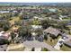 Aerial view of the property featuring mature trees, a circular driveway, and well-maintained landscaping at 7410 Locksley Ln, Lakeland, FL 33809