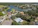 Aerial view of house with screened-in pool and fenced yard near a scenic lake at 7410 Locksley Ln, Lakeland, FL 33809