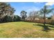 Expansive backyard featuring a well-maintained lawn and a sturdy wooden fence, providing privacy at 7410 Locksley Ln, Lakeland, FL 33809