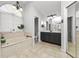 Bright bathroom boasts tile flooring, dual sinks, soaking tub with a window, and a private toilet room at 7410 Locksley Ln, Lakeland, FL 33809