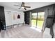 Bedroom with gray walls, sliding glass door leading to backyard and built in storage at 7410 Locksley Ln, Lakeland, FL 33809