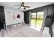 Cozy bedroom with carpeting, ceiling fan, a built-in nook and a sliding door to the backyard at 7410 Locksley Ln, Lakeland, FL 33809