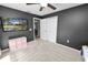 Nicely finished bedroom with dark accent walls, carpeting, and a TV at 7410 Locksley Ln, Lakeland, FL 33809