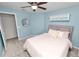 Comfortable bedroom with blue accent walls, carpeting, a ceiling fan and a closet at 7410 Locksley Ln, Lakeland, FL 33809