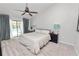 Bedroom with a view of the pool, ceiling fan, and neutral decor at 7410 Locksley Ln, Lakeland, FL 33809