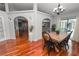 Open concept dining room with hardwood floors, designer lighting, and backyard views at 7410 Locksley Ln, Lakeland, FL 33809