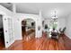 Open concept dining room with hardwood floors, designer lighting, and backyard pool views at 7410 Locksley Ln, Lakeland, FL 33809