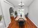 Elegant dining room with hardwood floors, chandelier lighting, and seamless kitchen access at 7410 Locksley Ln, Lakeland, FL 33809