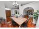 Dining area featuring hardwood floors, natural light, and designer lighting at 7410 Locksley Ln, Lakeland, FL 33809