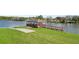 Waterfront home featuring a private dock and boat ramp access to a serene lake at 7410 Locksley Ln, Lakeland, FL 33809