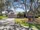 Charming single-Gathering home with beautiful mature trees and a well-manicured front yard at 7410 Locksley Ln, Lakeland, FL 33809
