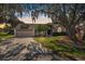 Inviting single-Gathering home with mature trees, a well-kept lawn, and an attached garage at 7410 Locksley Ln, Lakeland, FL 33809