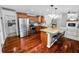 Open-concept kitchen featuring a breakfast bar, stainless steel appliances, and ample cabinet space at 7410 Locksley Ln, Lakeland, FL 33809