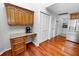 Bright kitchen includes wooden cabinetry, a workstation area, stainless steel appliances, and hardwood floors at 7410 Locksley Ln, Lakeland, FL 33809