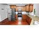 This lovely kitchen features stainless steel appliances, granite countertops, white subway tile, and hardwood floors at 7410 Locksley Ln, Lakeland, FL 33809