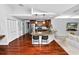 Open kitchen featuring a granite countertop, stainless steel appliances, and hardwood floors at 7410 Locksley Ln, Lakeland, FL 33809