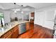 Spacious kitchen with wooden cabinetry, stainless steel appliances, granite countertops, and an adjacent dining area at 7410 Locksley Ln, Lakeland, FL 33809