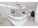 Cozy living room with a fireplace, neutral decor, a ceiling fan, and a wall-mounted television at 7410 Locksley Ln, Lakeland, FL 33809