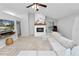 The light-filled living room features a fireplace and seamlessly connects to other areas at 7410 Locksley Ln, Lakeland, FL 33809